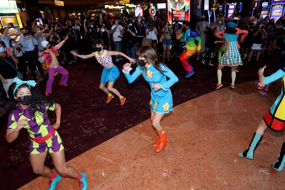 The cast of The Beatles LOVE entertain guests, employees, and fans during a celebratory pop-up ...