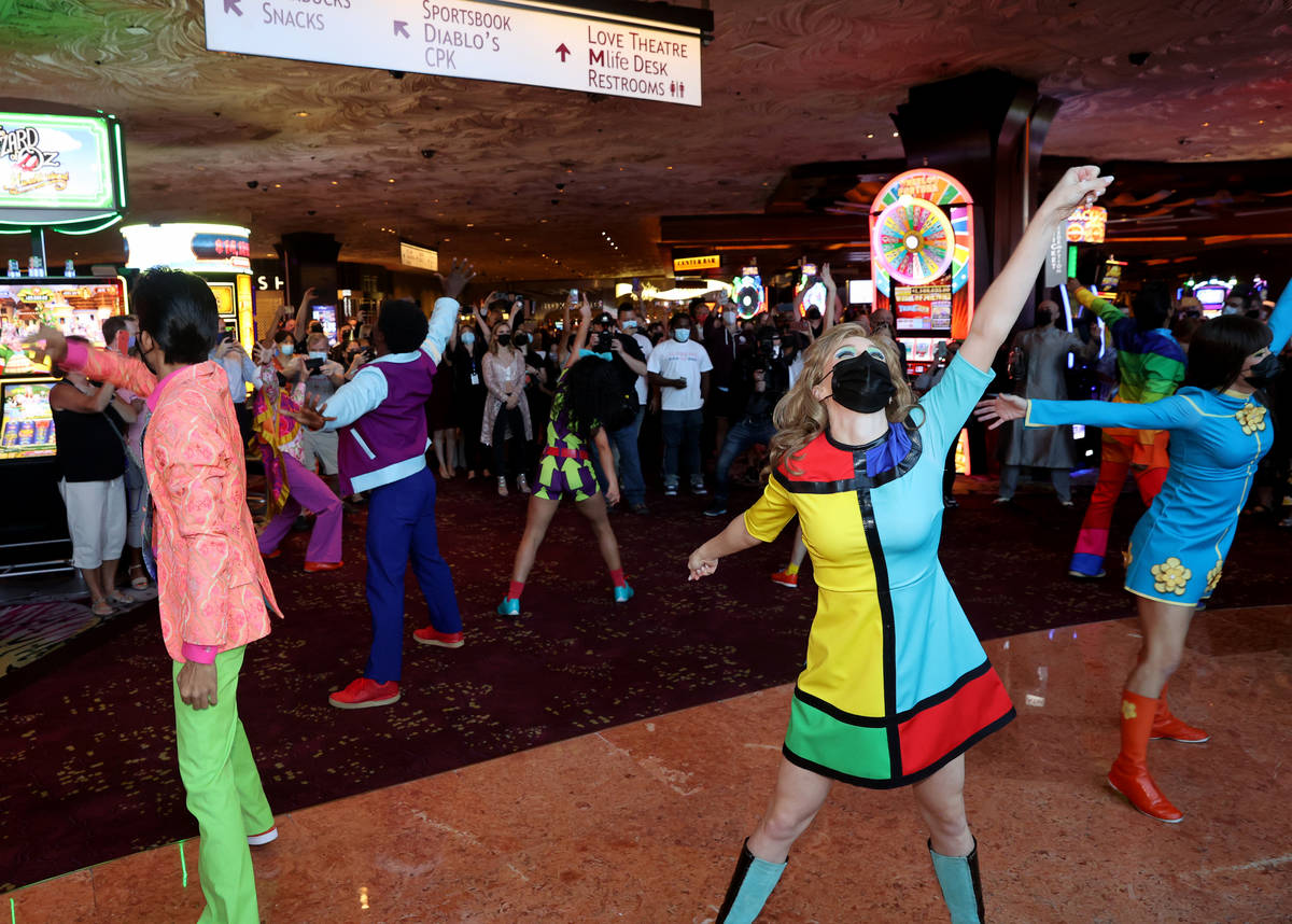 The cast of The Beatles LOVE entertain guests, employees, and fans during a celebratory pop-up ...