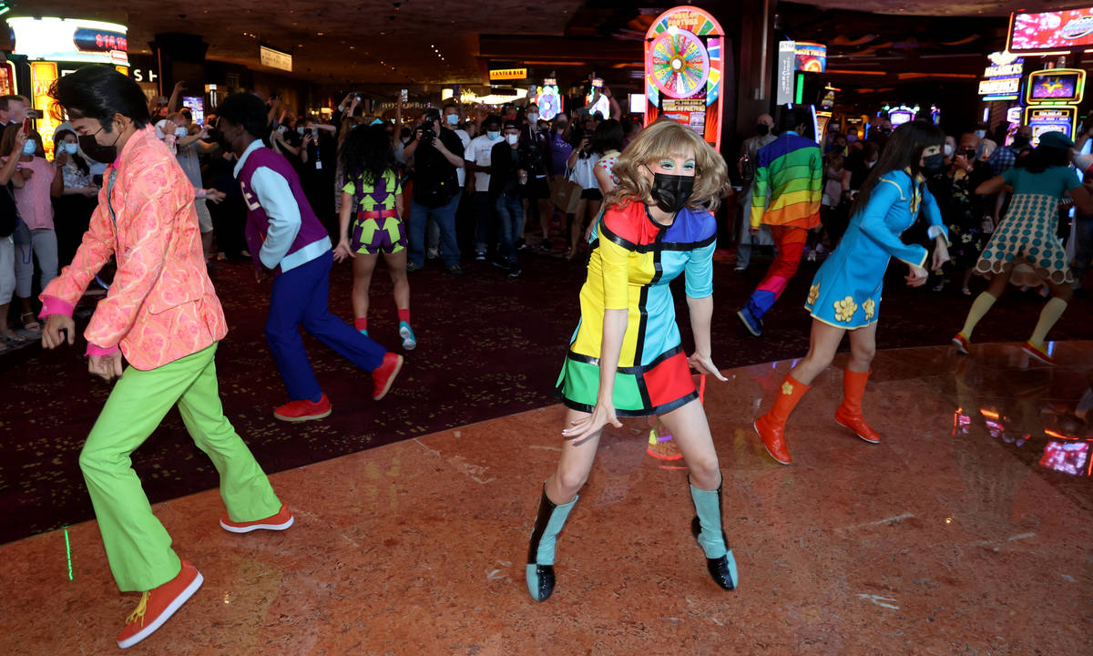 The cast of The Beatles LOVE entertain guests, employees, and fans during a celebratory pop-up ...