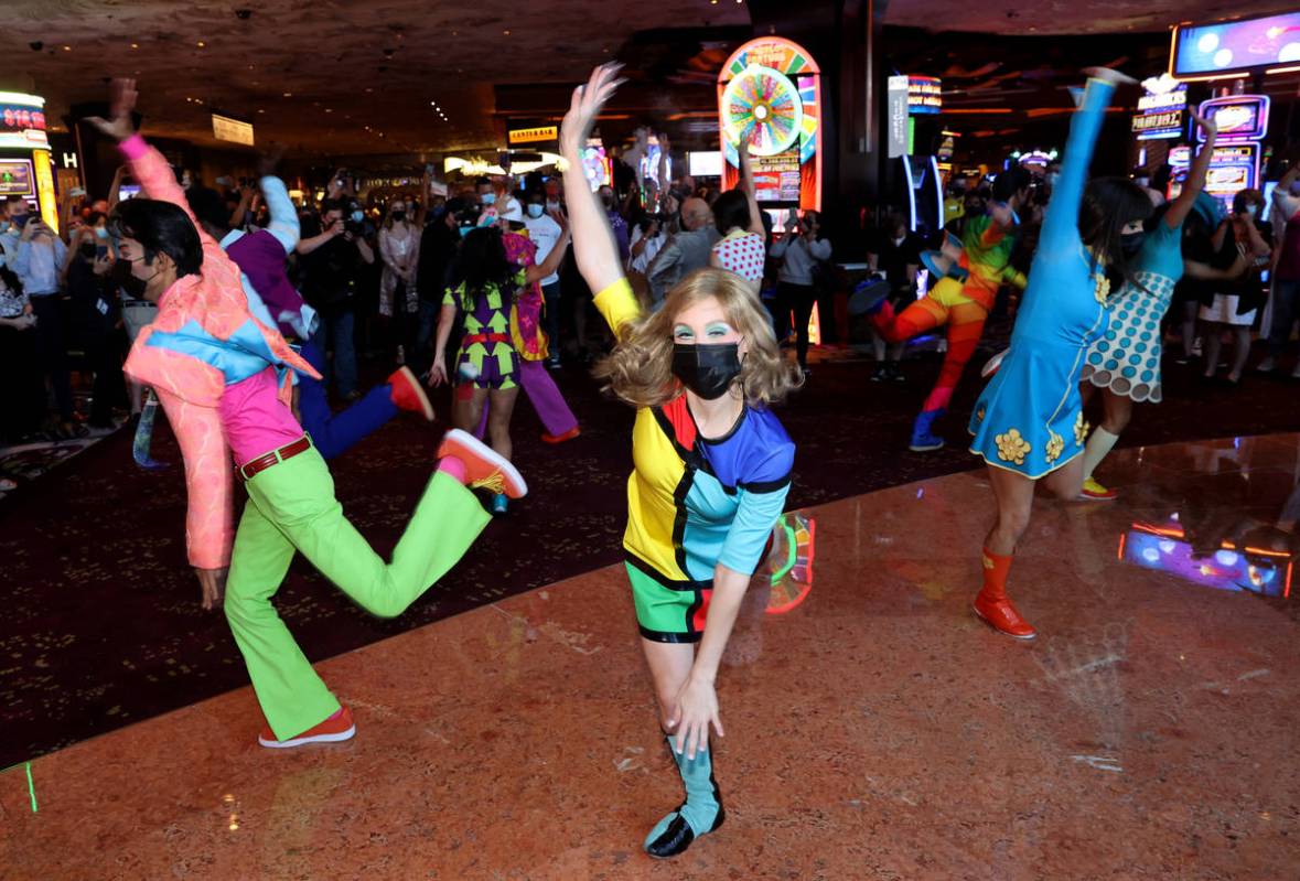 The cast of The Beatles LOVE entertain guests, employees, and fans during a celebratory pop-up ...