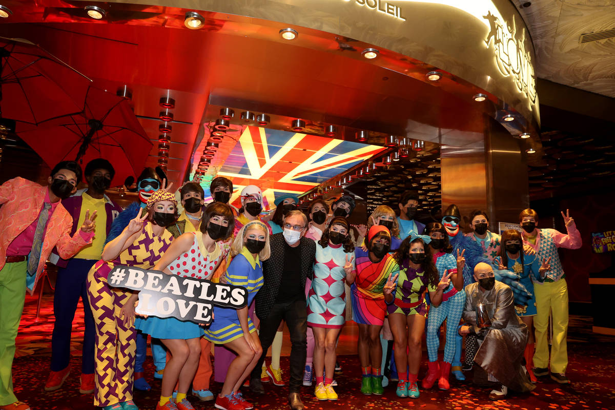 The cast of The Beatles LOVE, including Daniel Lamarre, president and CEO, center, entertain gu ...
