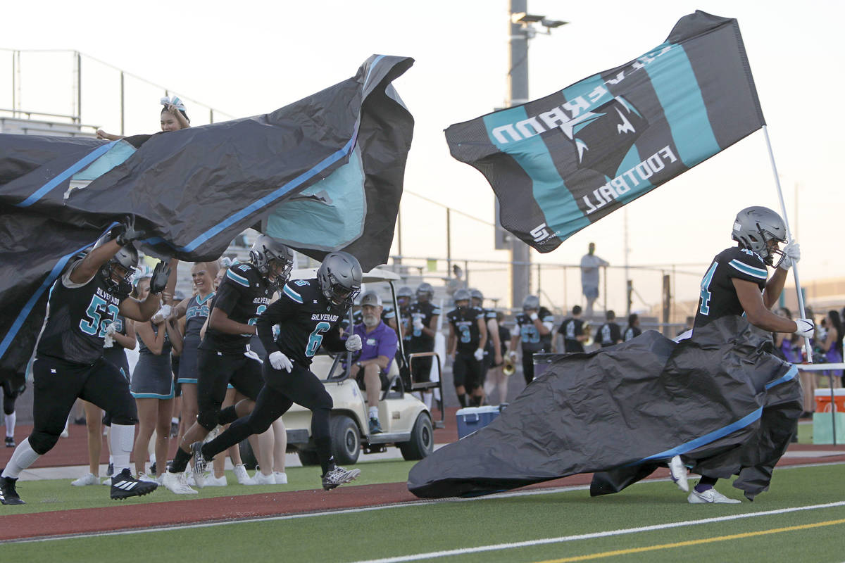 Silverado High School players run into the field before a football game against Shadow Ridge Hi ...