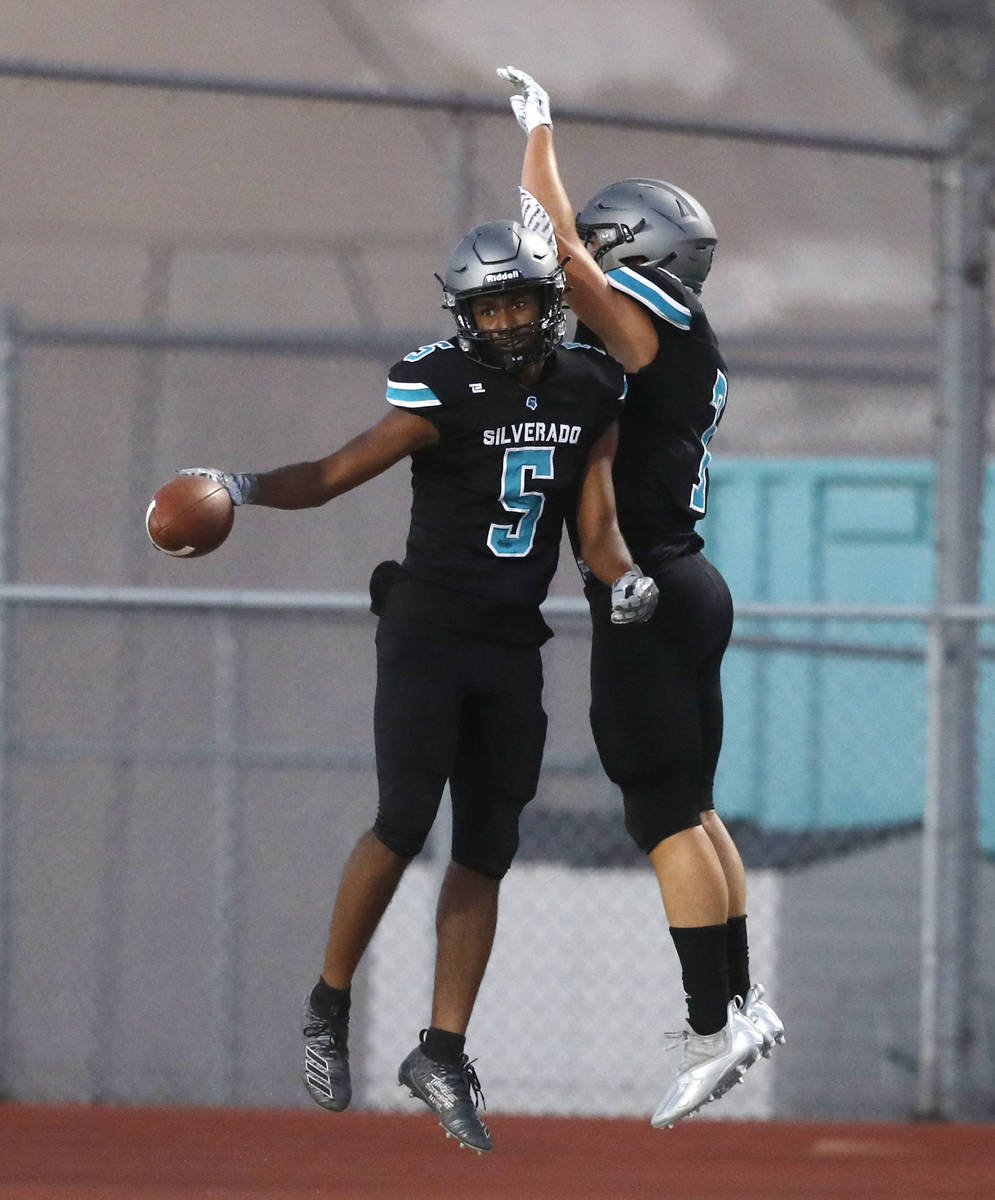 Silverado High School's Jaden Thrower (5) celebrates his touchdown with Bryson Tunnell (7) duri ...