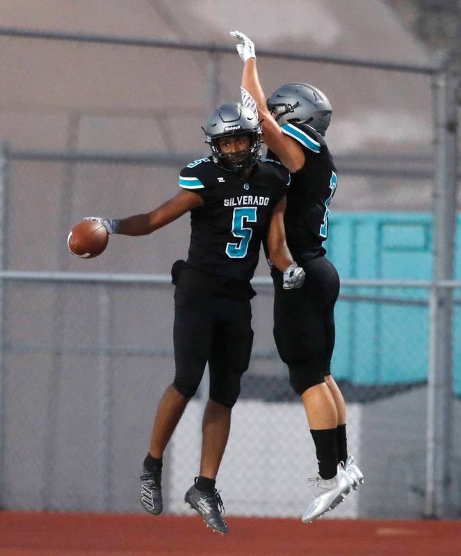 Silverado High School's Jaden Thrower (5) celebrates his touchdown with Bryson Tunnell (7) duri ...