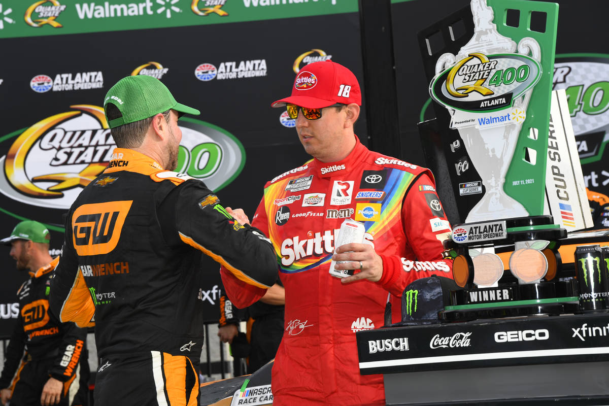 Kurt Busch is congratulated by his brother Kyle Busch after winning a NASCAR Cup Series auto ra ...