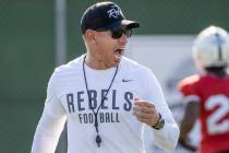 UNLV Head Coach Marcus Arroyo yells some encouragement to his players during a drill in footbal ...