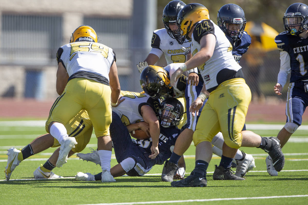 Cheyenne quarterback Kaleigha Plett (6) takes a sack from Clark linebacker Sebastian Reynaga (4 ...