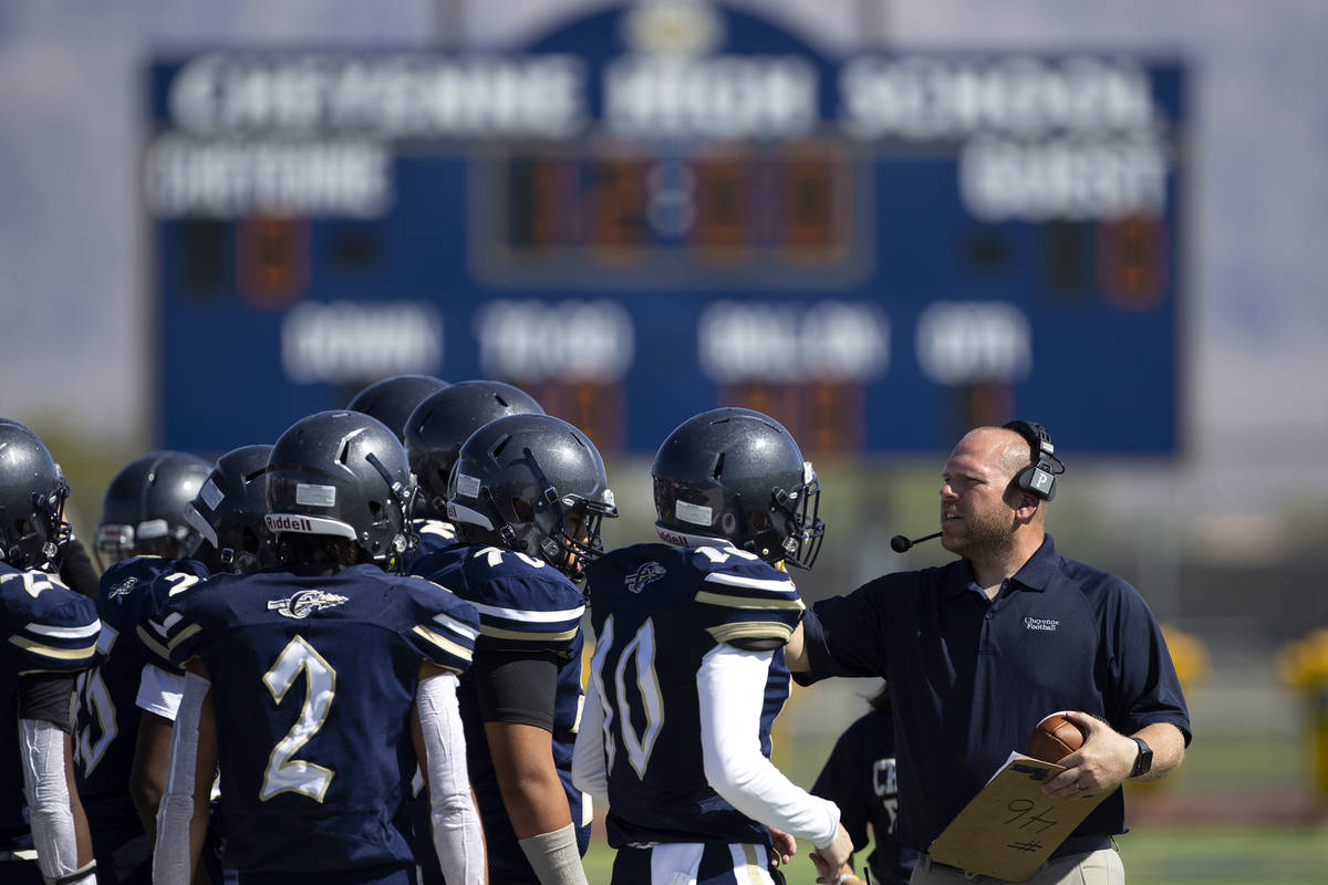 Cheyenne's head coach Jared Bennett gathers the team during their football game against Clark H ...