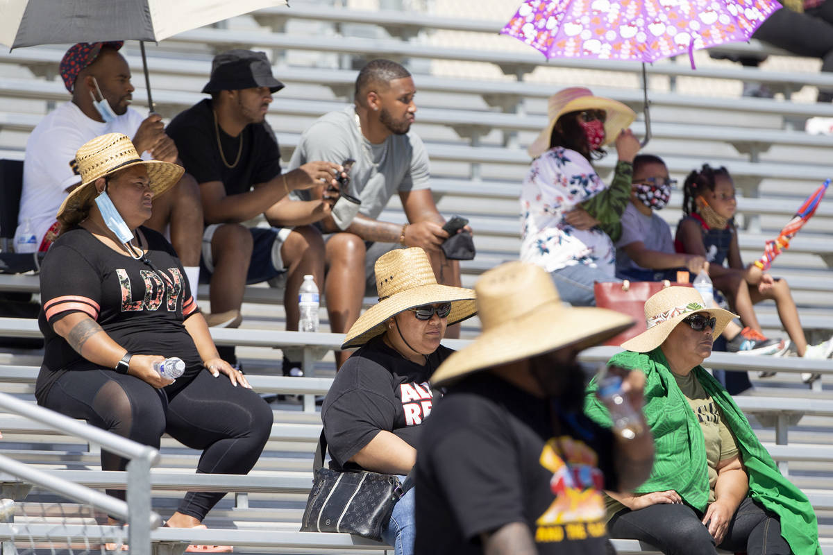 Cheyenne fans attempt to stay cool in at least 100-degree weather during a football game agains ...