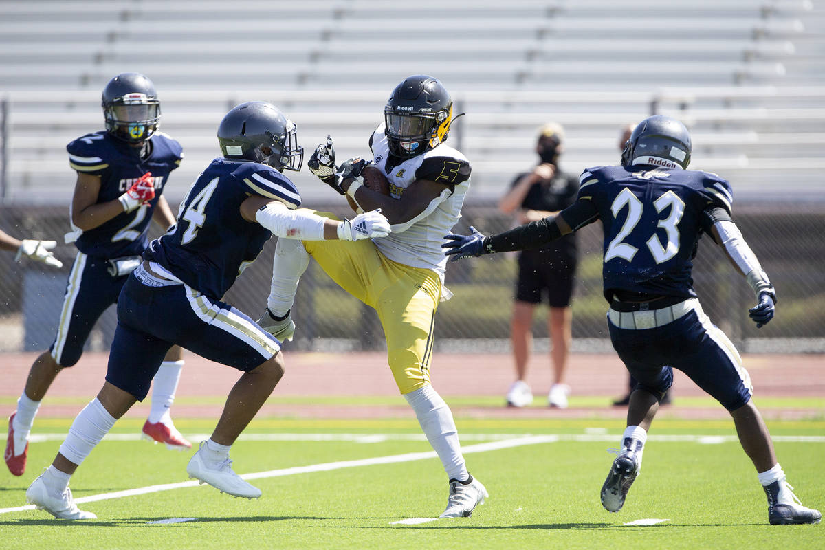 Clark running back D'on Williams (5) catches a pass as Cheyenne linebacker Ruben Madrigal (44) ...
