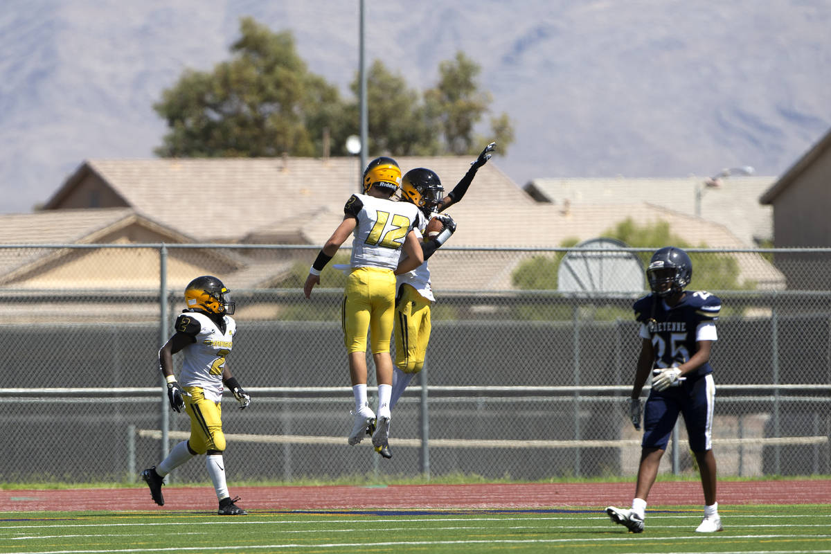 Clark wide receivers Salik Wilson (22) and Marquise Hill (27) jump in celebration of Hill's tou ...