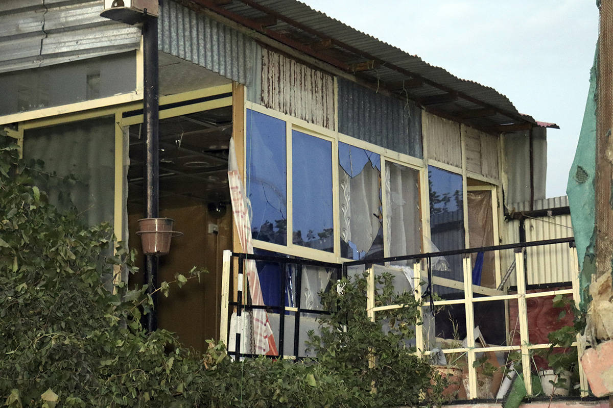 A broken window of a house is seen after U.S. drone strike in Kabul, Afghanistan, Sunday, Aug. ...