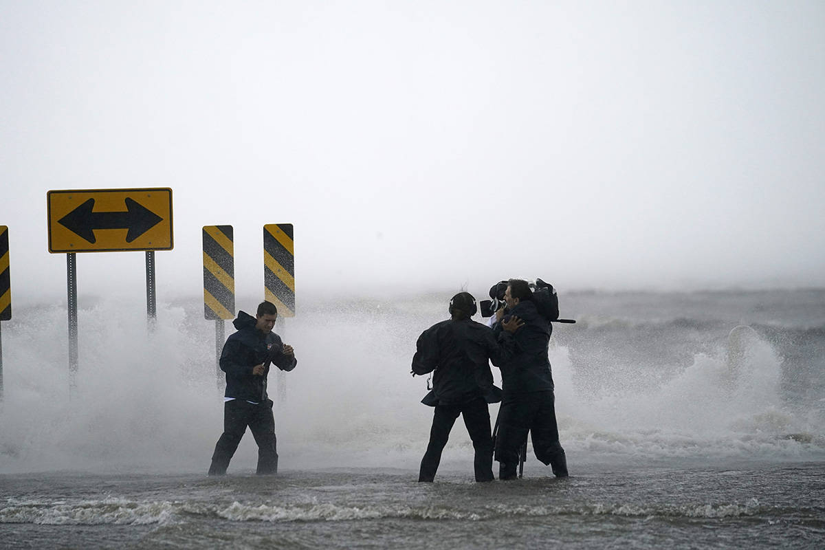 A news crew reports on the edge of Lake Pontchartrain ahead of approaching Hurricane Ida in New ...