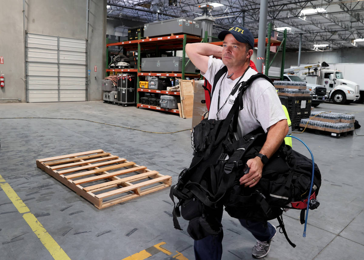 Members of the FEMA Nevada Task Force 1 Urban Search & Rescue team, including Henderson Fir ...