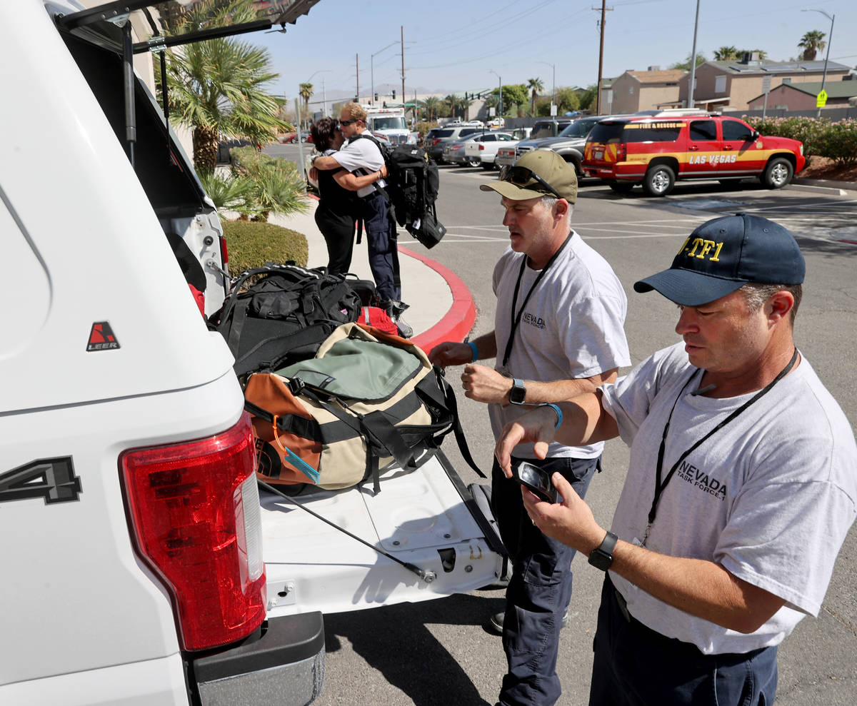 Members of the FEMA Nevada Task Force 1 Urban Search & Rescue team, including Israel Wilkin ...