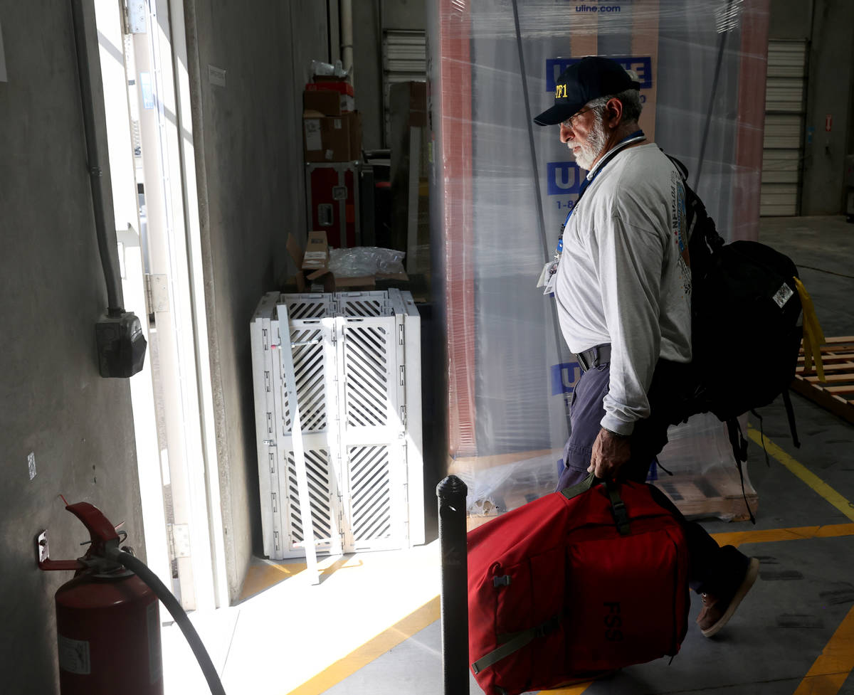 Members of the FEMA Nevada Task Force 1 Urban Search & Rescue team, including Alex Martinez ...