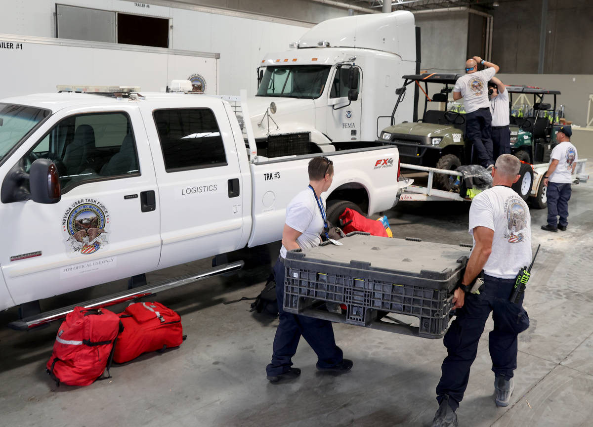 Members of the FEMA Nevada Task Force 1 Urban Search & Rescue team, including Clark County ...