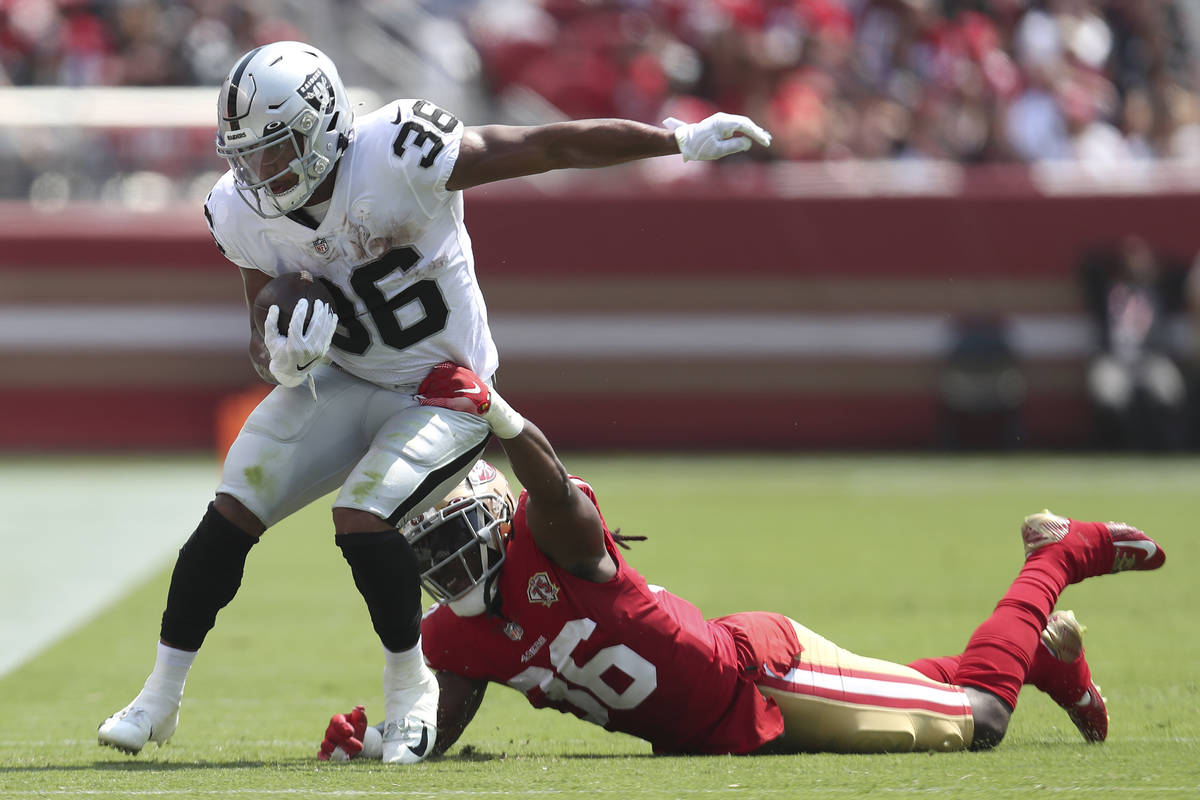 Las Vegas Raiders running back Trey Ragas, left, runs against San Francisco 49ers defensive bac ...