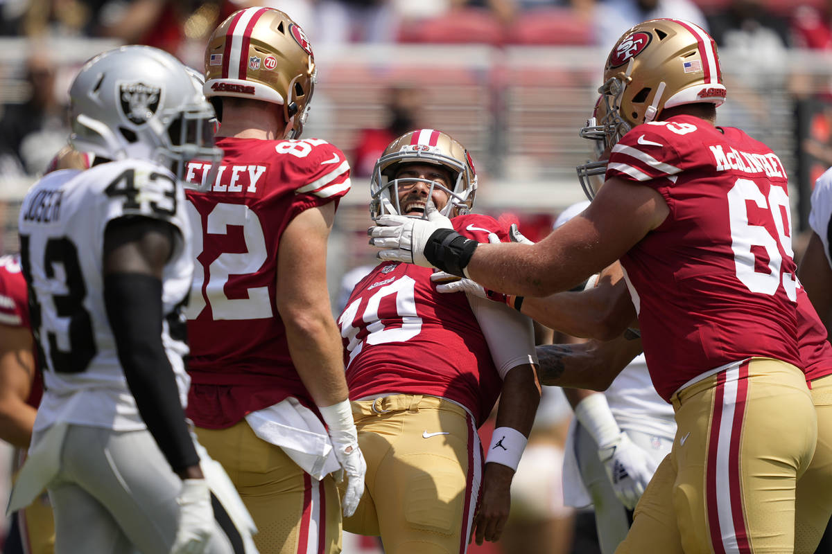 San Francisco 49ers quarterback Jimmy Garoppolo, center, celebrates with teammates after scorin ...