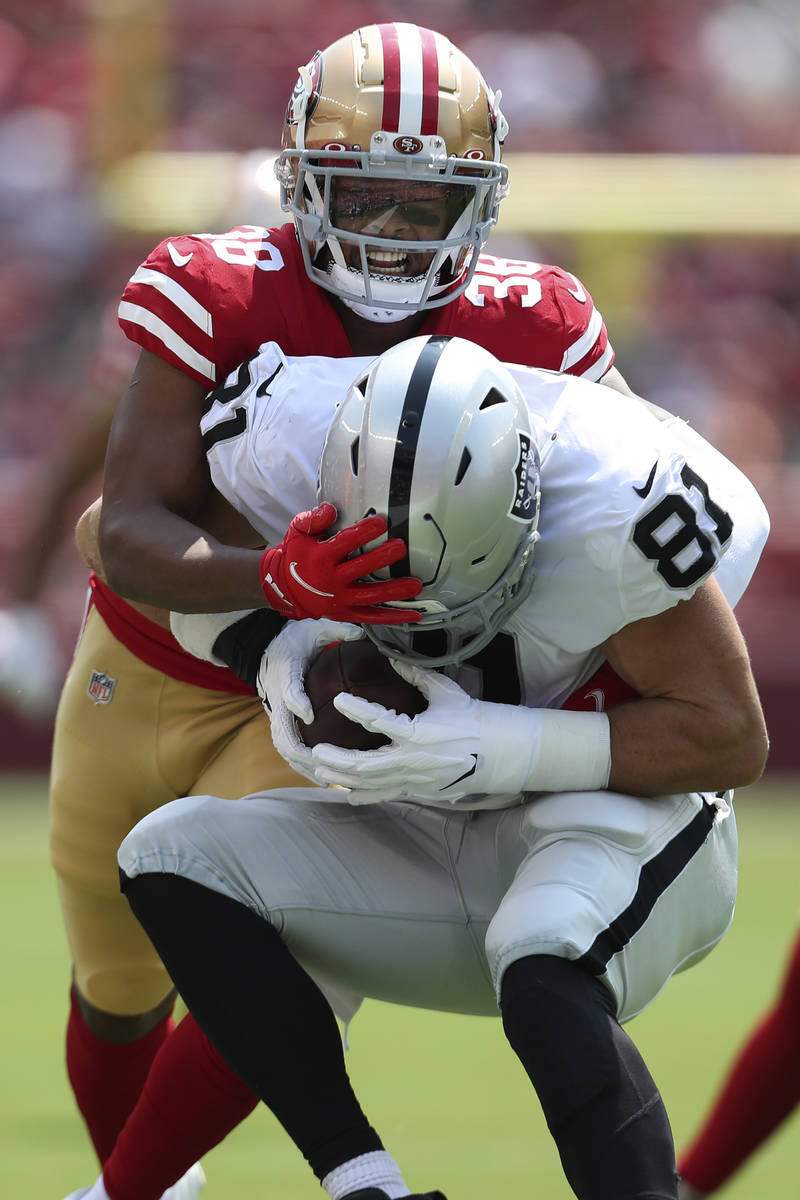 San Francisco 49ers cornerback Deommodore Lenoir, top, tackles Las Vegas Raiders tight end Alex ...