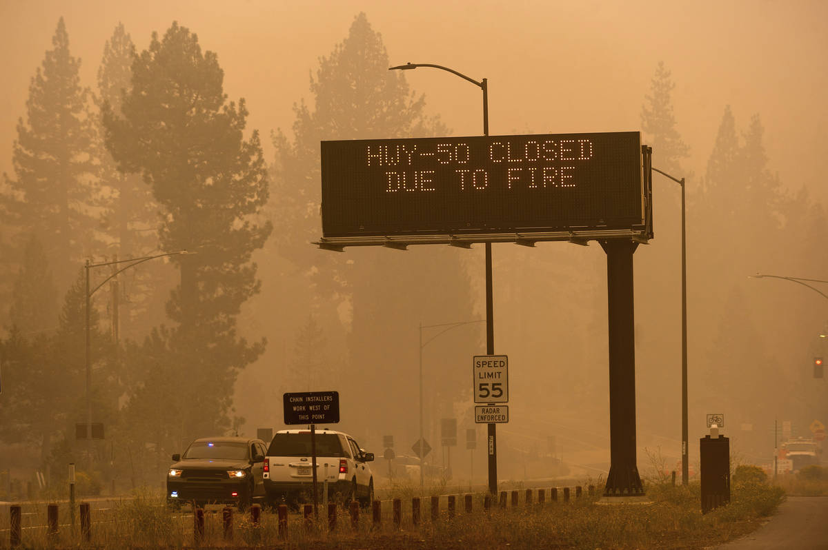 A sign in Eldorado County, Calif., warns motorists about the closure of Highway 50, which is sh ...