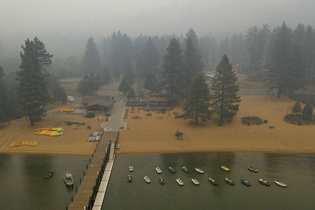 Smoke from the Caldor Fire fills the sky above Lake Tahoe's Zephyr Cove in Douglas County, Nev. ...