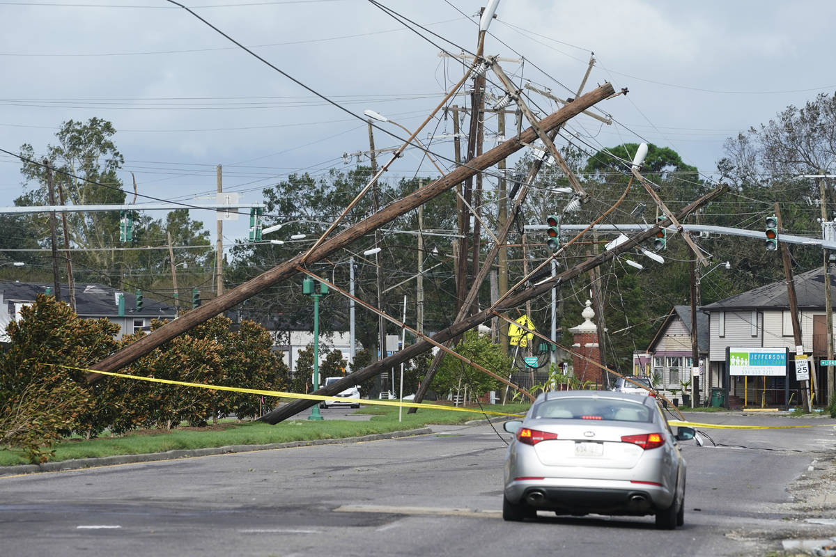 Traffic diverts around downed power lines Monday, Aug. 30, 2021, in Metairie, La. A fearsome Hu ...