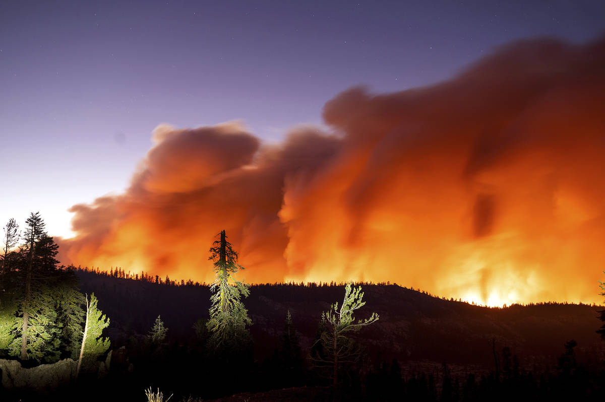Seen in a long camera exposure, the Caldor Fire burns on Sunday, Aug. 29, 2021, in Eldorado Nat ...