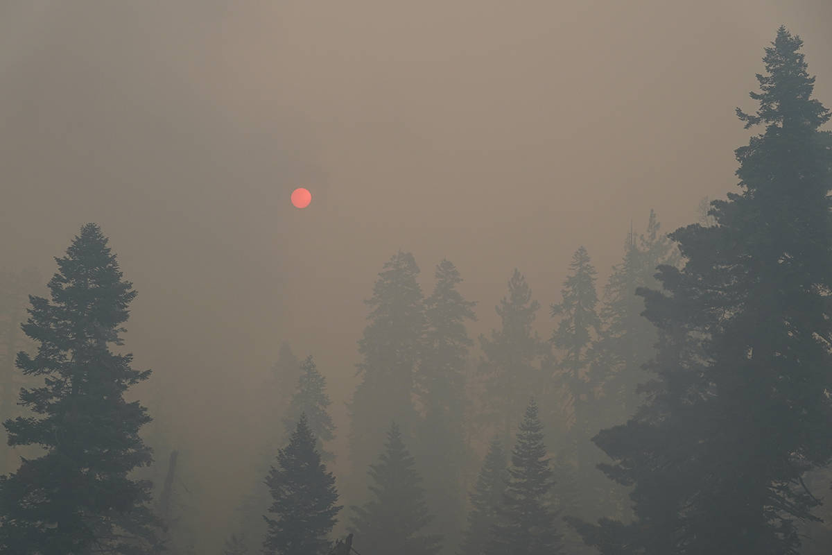 The sun is visible through thick smoke generated by Caldor Fire in South Lake Tahoe, Calif., Tu ...