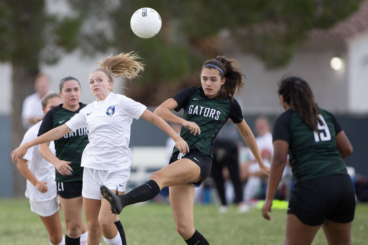 Green Valley's Chase Northam (14) attempts to pass while Foothill's Emma Rietz (9) falls behind ...