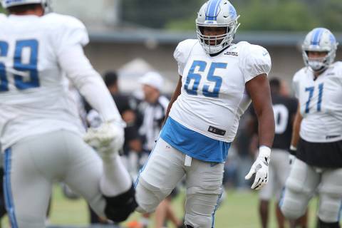 Detroit Lions offensive guard Tyrell Crosby (65) stretches at the team's NFL training camp in N ...