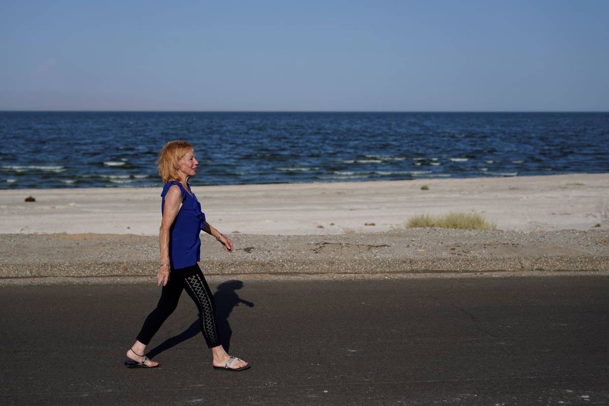 Carlene Ness walks on a road along the Salton Sea in Desert Shores, Calif., Wednesday, July 14, ...