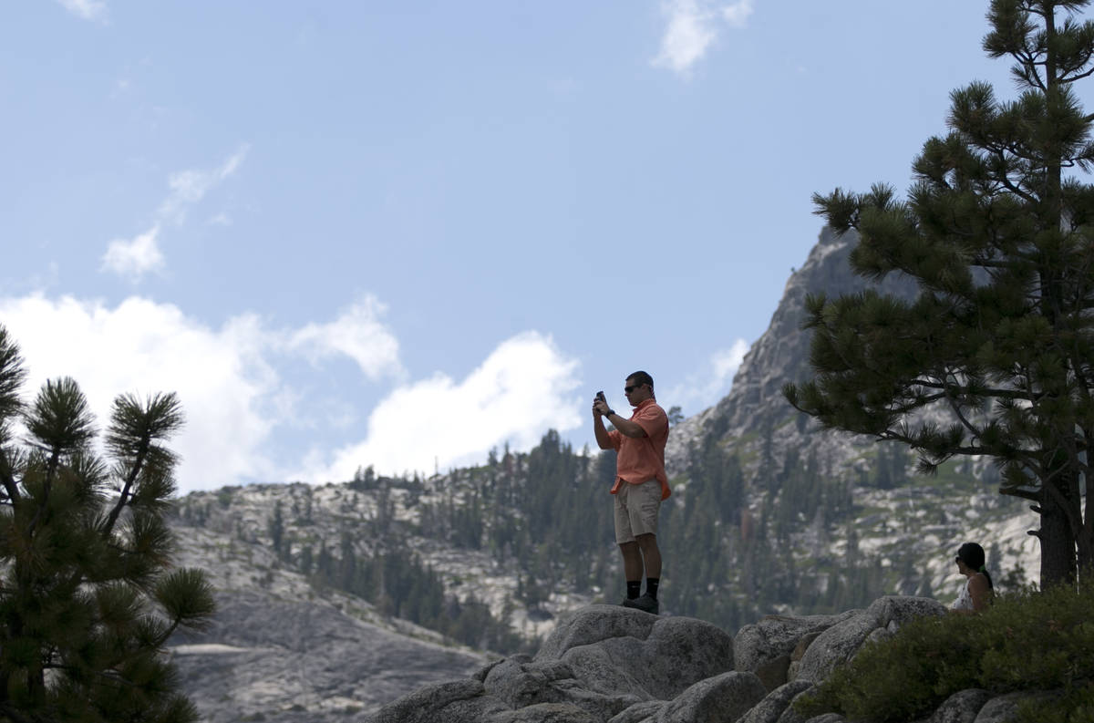 In this Aug. 8, 2017 file photo, a man gets a scenic view of Emerald Bay near South Lake Tahoe, ...