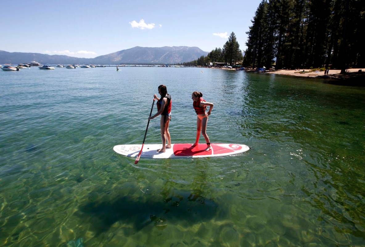 In this Aug. 20, 2019, file photo, Freya Mayo, left, and her sister Evie, of London, try out a ...