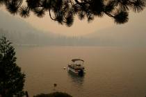 In this Tuesday, Aug. 24, 2021 file photo, smoke from the Caldor Fire, shrouds Fallen Leaf Lake ...