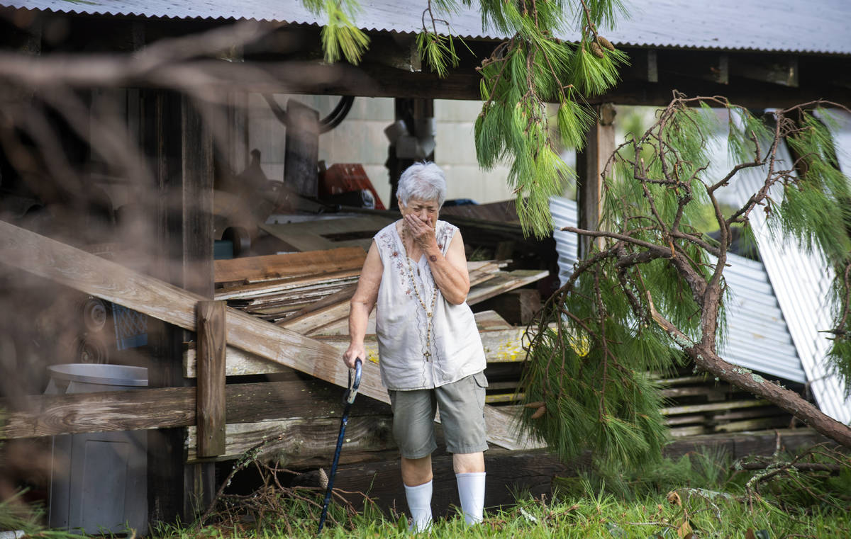 Surveying the damage for the first time, Sharon Orlando tries to hold back tears on the morning ...