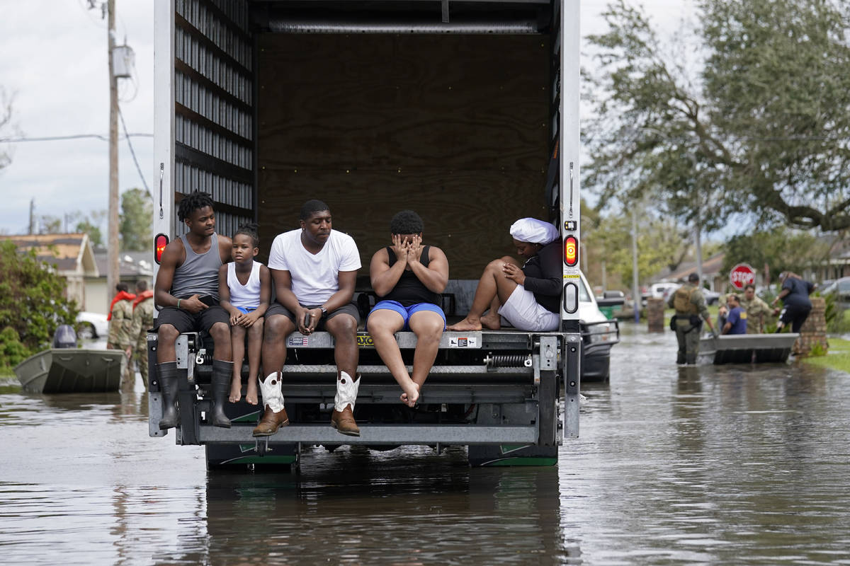 People are evacuated from floodwaters in the aftermath of Hurricane Ida in LaPlace, La., Monday ...