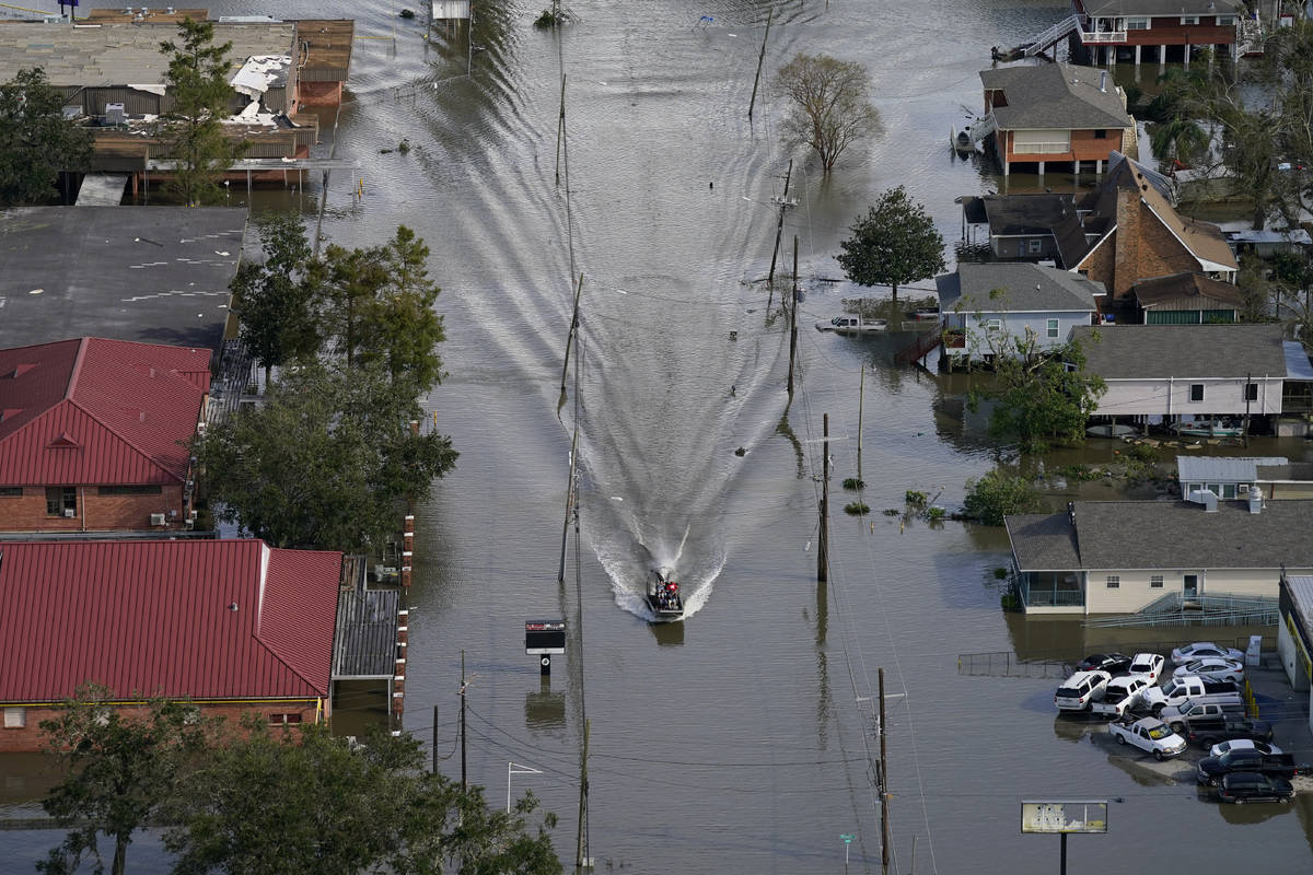 An Airboat glides over a city street in the aftermath of Hurricane Ida, Monday, Aug. 30, 2021, ...