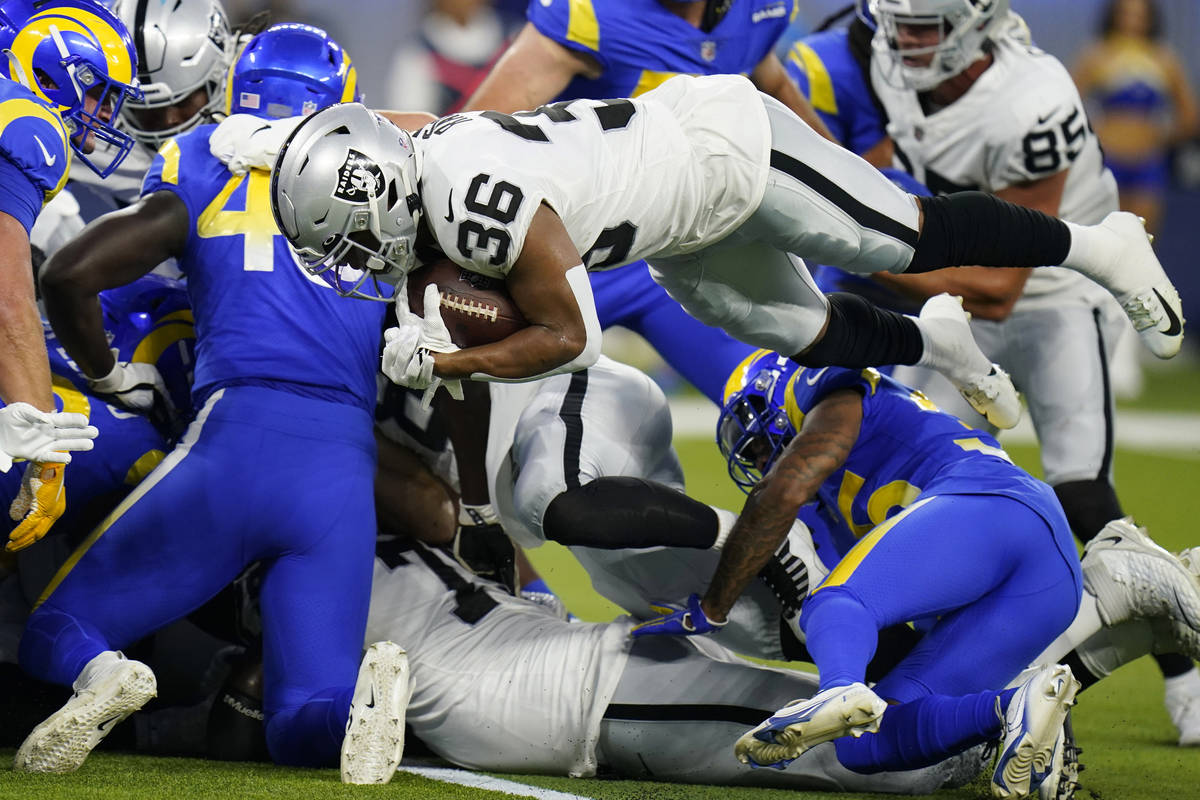 Las Vegas Raiders running back Trey Ragas lunges into the end zone for a rushing touchdown duri ...