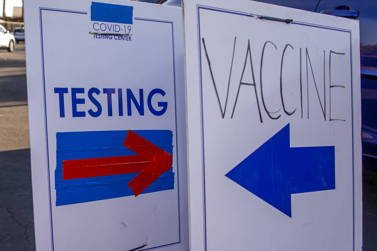 This August 5, 2021, file photo shows direction signs for COVID-19 testing site and the vaccina ...