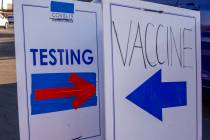This August 5, 2021, file photo shows direction signs for COVID-19 testing site and the vaccina ...