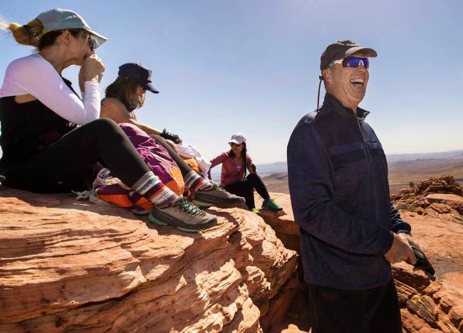 52 Peaks founder/leader Branch Whitney, right, shares a laugh with fellow hikers at the top of ...