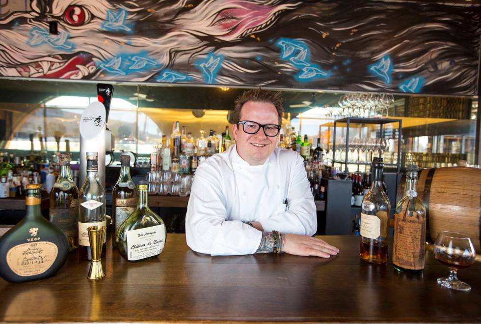 Brian Howard, chef and owner of Sparrow and Wolf, poses with his extremely rare spirits at his ...