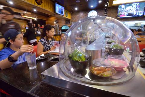 A conveyor belt brings food directly to diners at the Chubby Cattle restaurant. (rjmagazine)