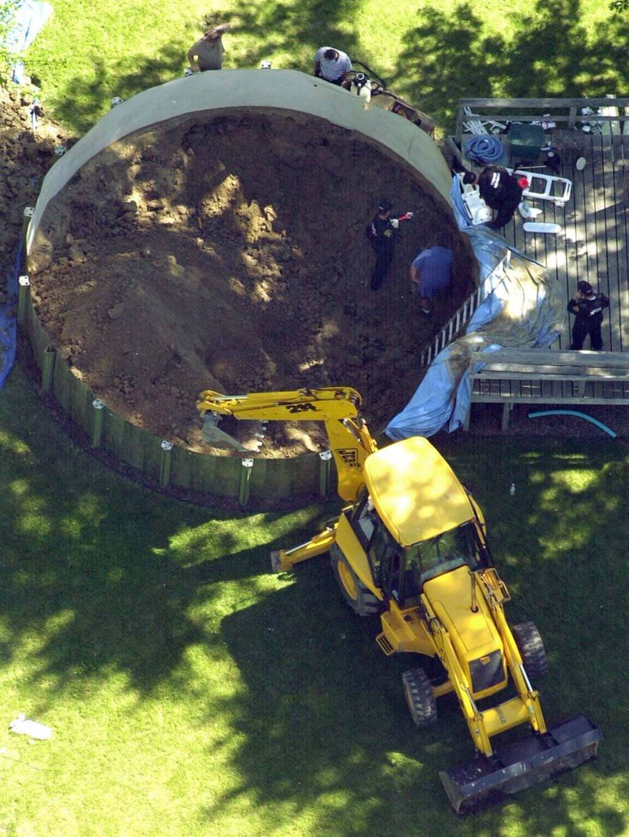 In this July 16, 2003 file photo, authorities search under a backyard pool in Hampton Township, ...