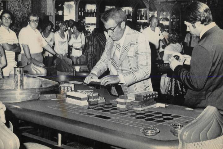 Agents count chips at a roulette wheel while Aladdin Hotel casino employees watch after state g ...