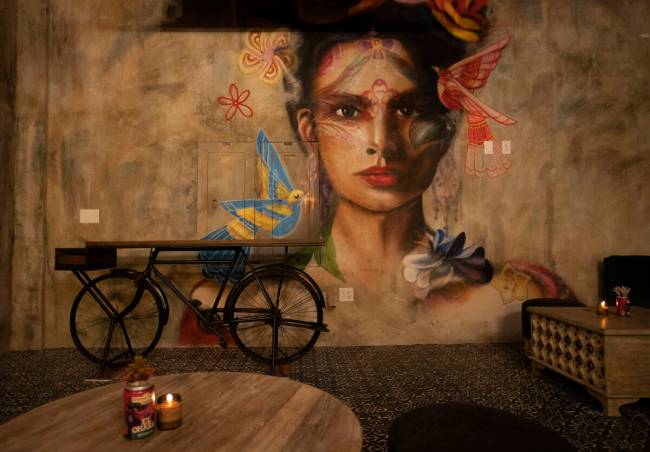 The artist Mallory Dawn painted this mural, which can be seen in the speakeasy bar in Màs Por Favo ...
