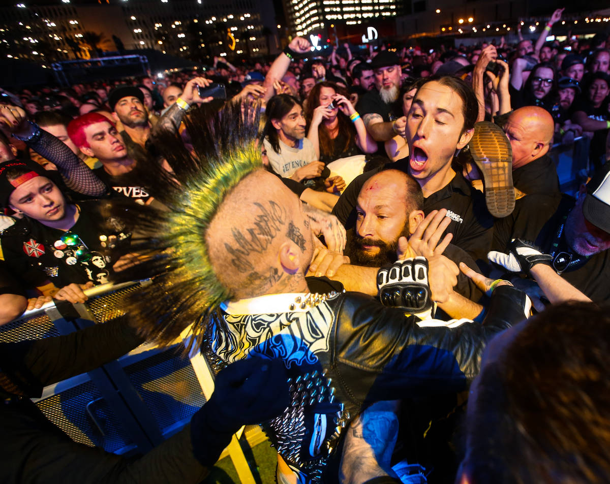 A security guard tries to break up a pair of attendees that jumped over the barricade during th ...