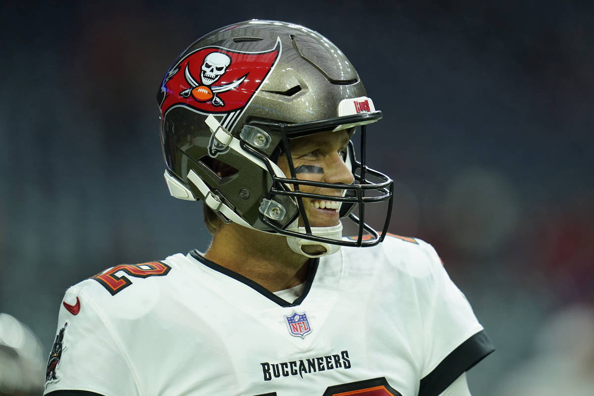 Tampa Bay Buccaneers quarterback Tom Brady (12) smiles during pregame warmups before an NFL pre ...