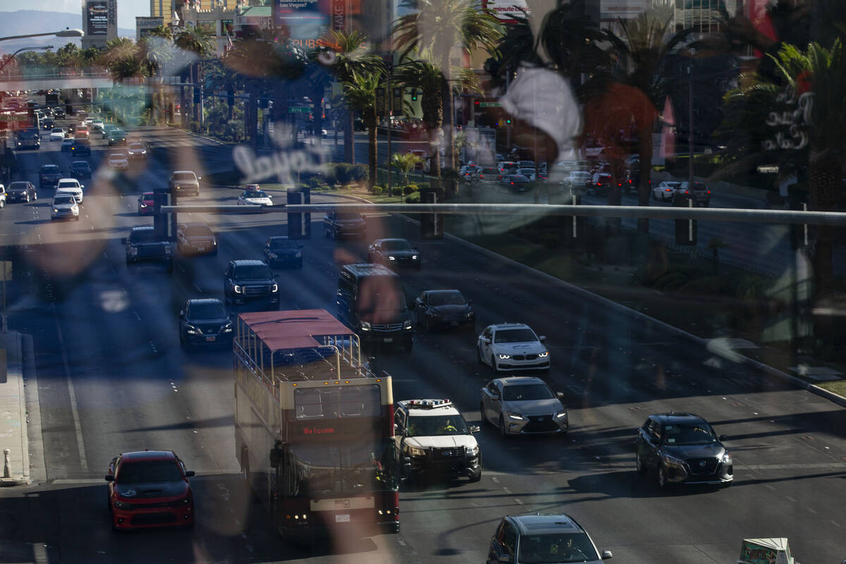 A Metropolitan police squad car, center, patrols Las Vegas Boulevard during Labor Day weekend o ...